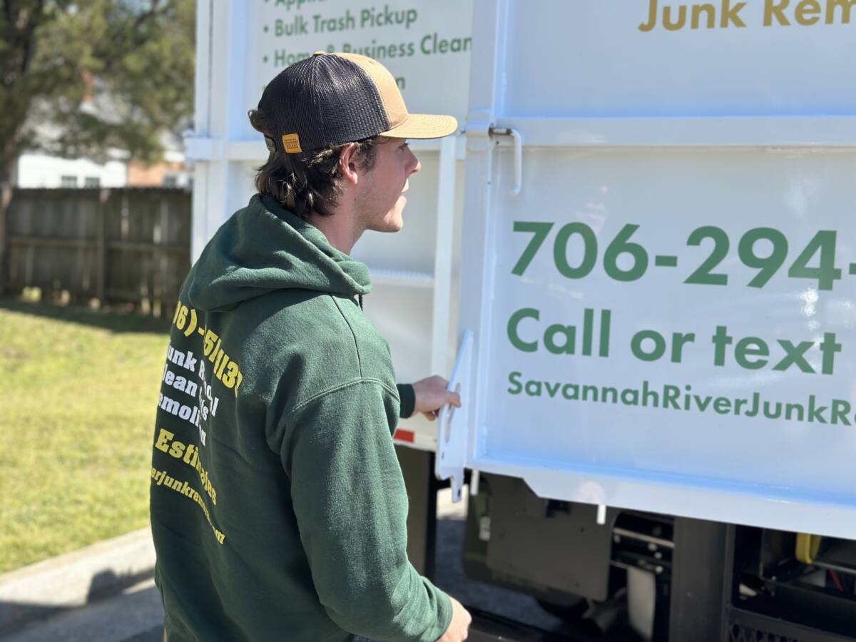 Savannah River Junk Removal Man Reading Sign