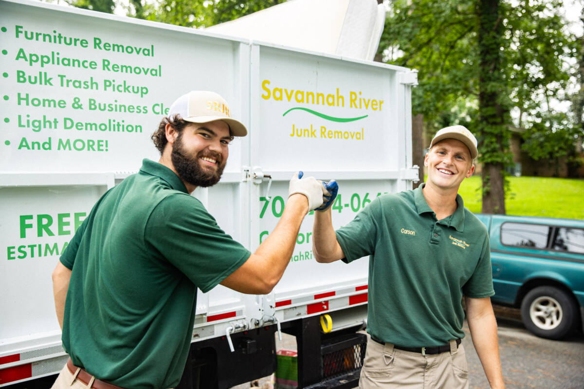 Savannah Junk Removal Experts Posing In Front of a Junk Truck