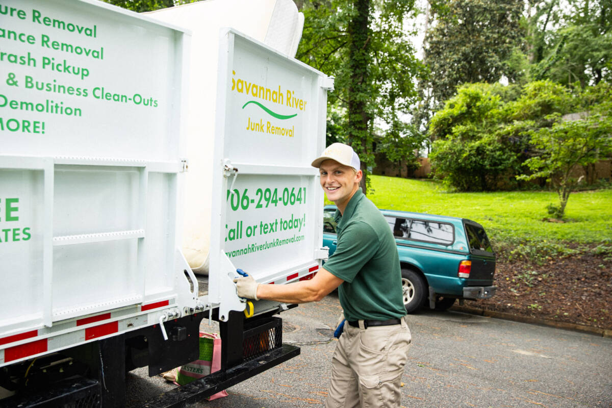 Savannah Junk Removal Expert Posing In Front of a Junk Truck