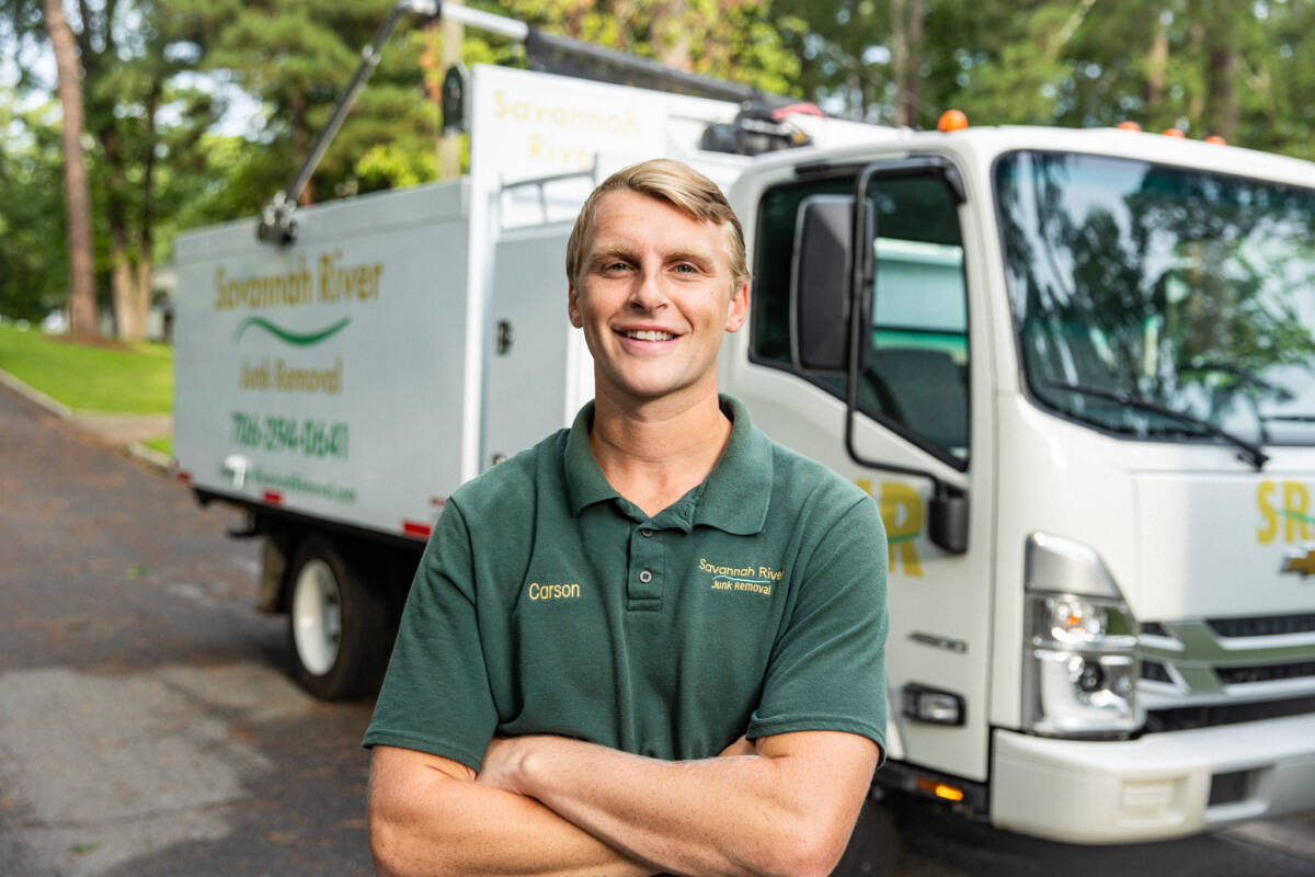 Savannah Junk Removal Expert Posing In Front of a Junk Truck